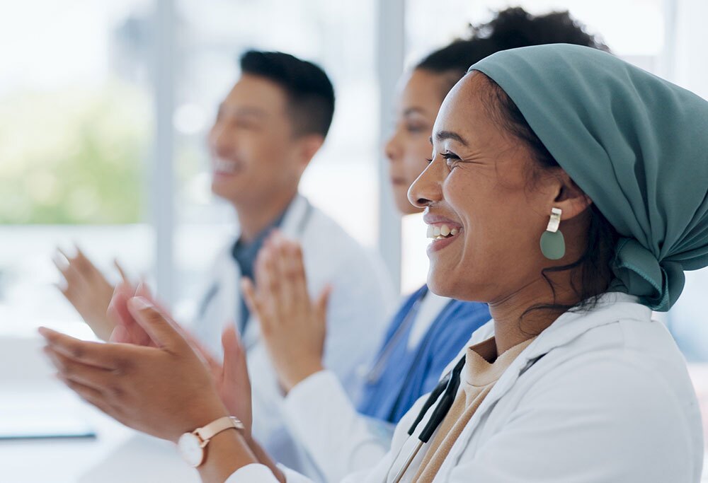 A row of doctors clapping.