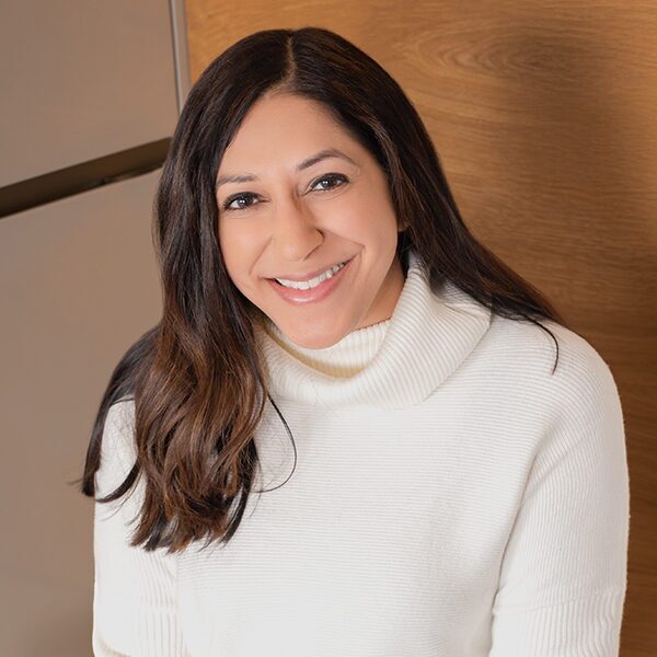 Portrait of Priya Bathija in white sweater.