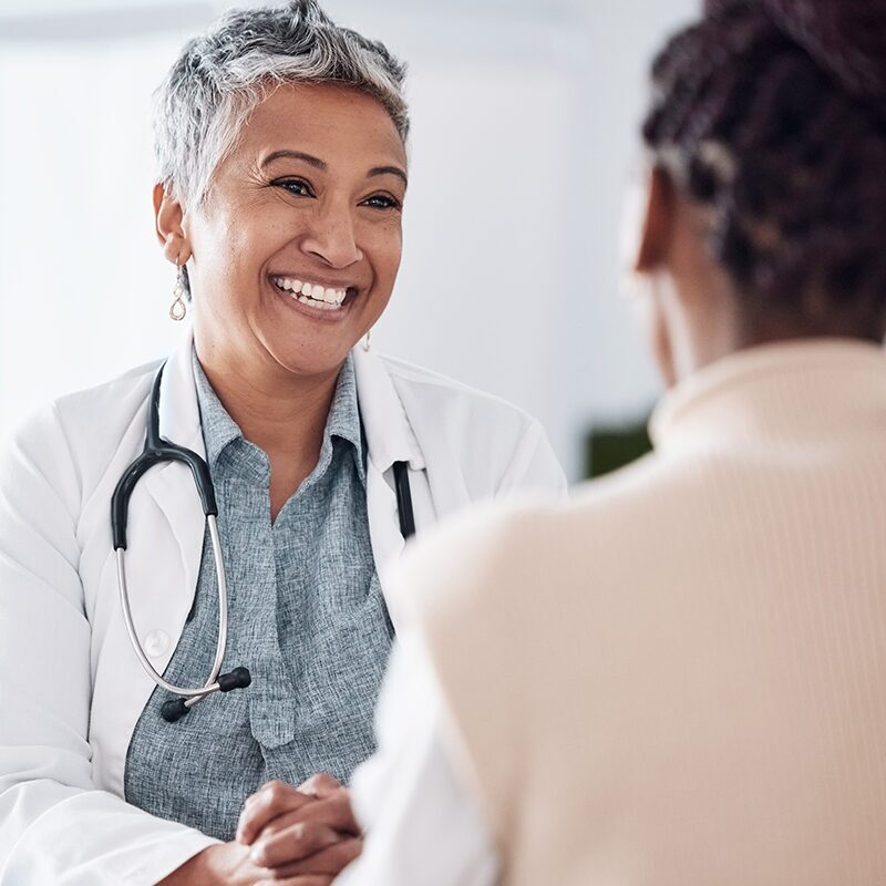 asian physician in consultation with femail patient.