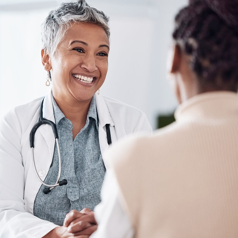 asian physician in consultation with femail patient.
